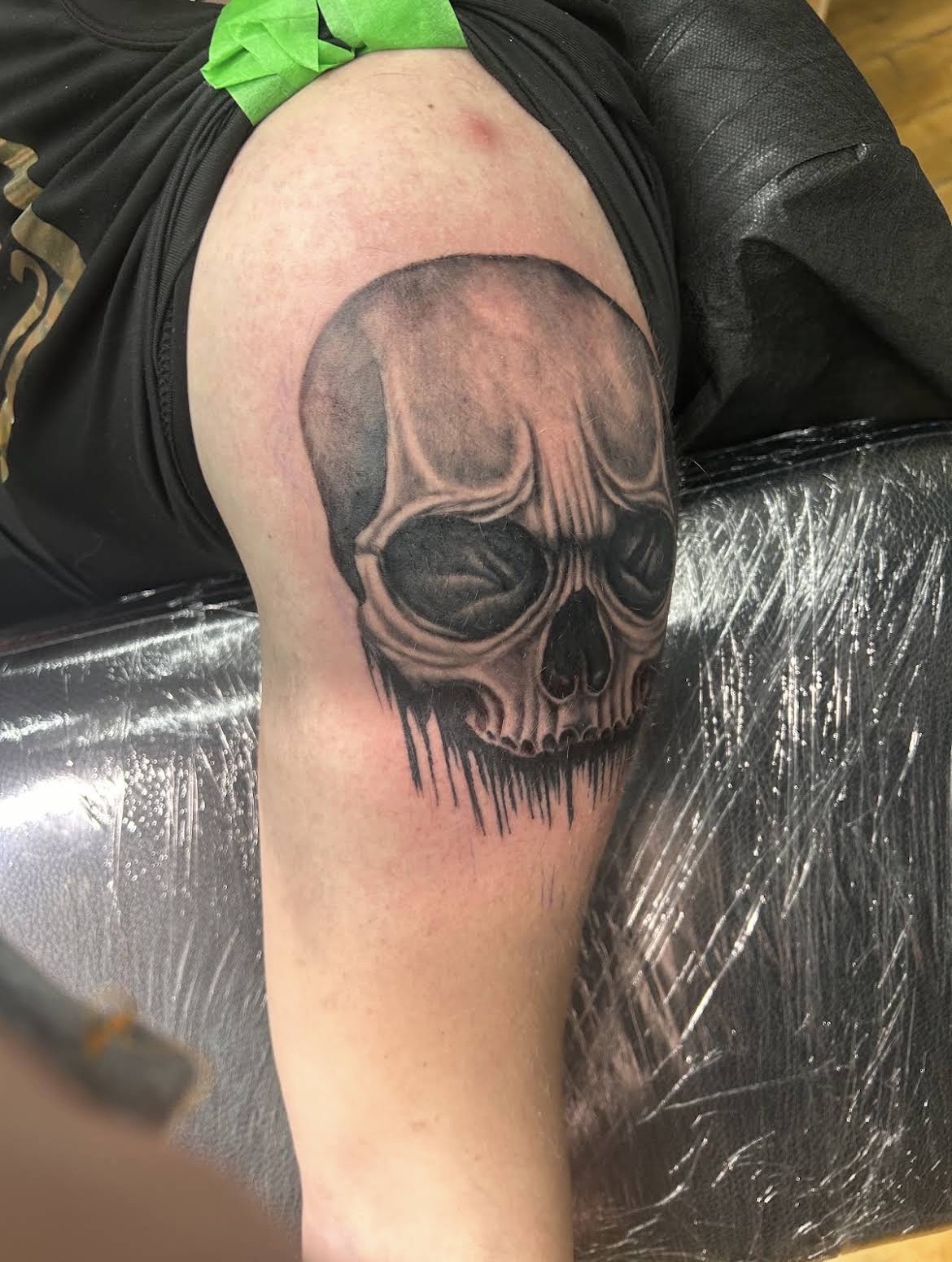Black and grey skull tattoo on shoulder