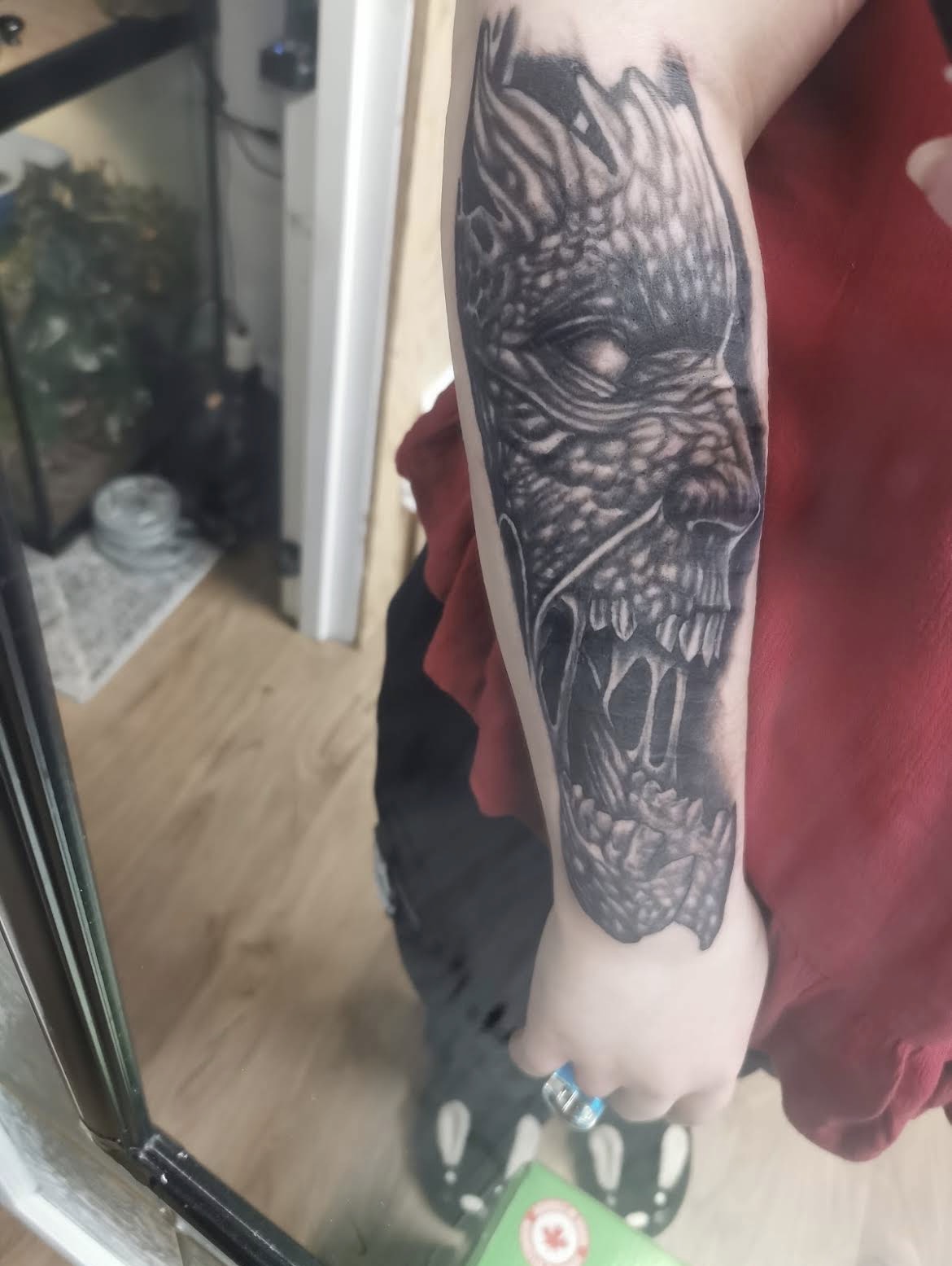 Dark realism dragon forearm tattoo